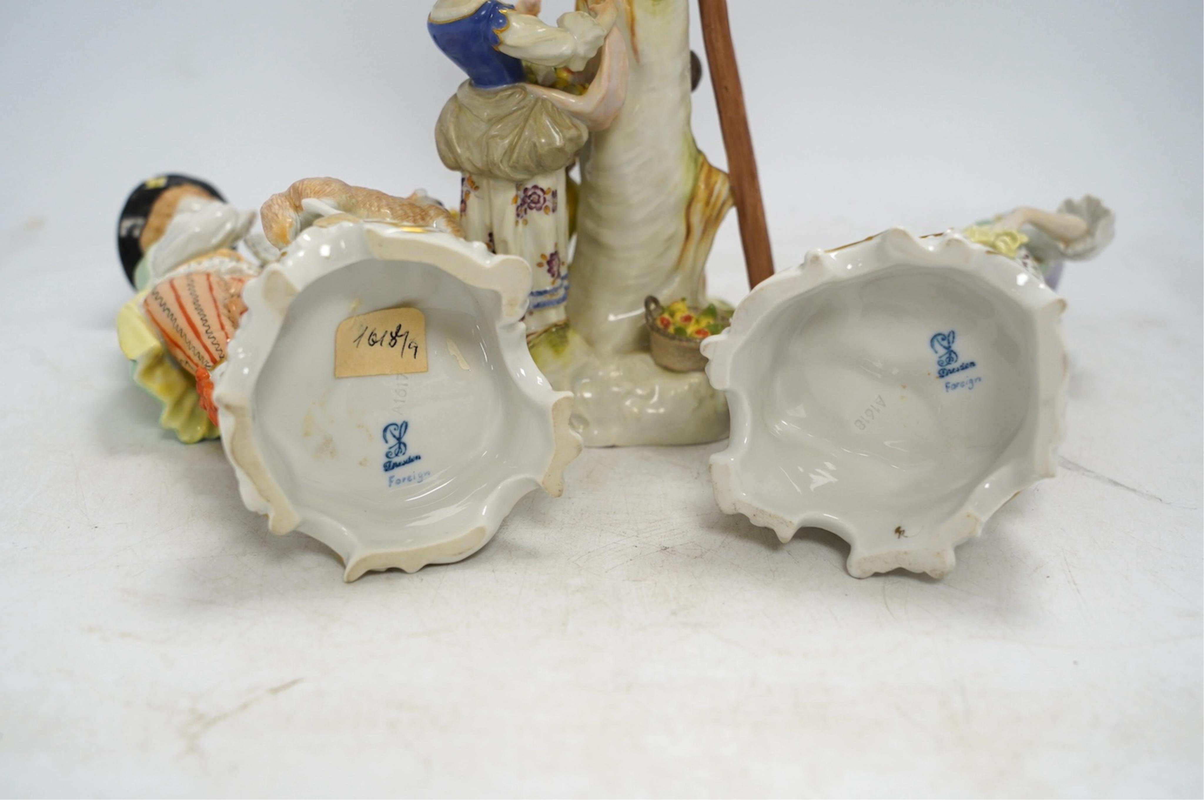 A Meissen apple pickers figure group and a pair of Dresden porcelain groups, tallest 29cm. Condition - some damage